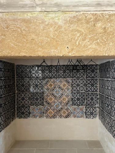 a wall with mosaics on it in a room at Villa ArboreA in Squinzano