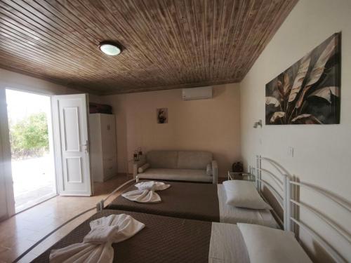 a living room with a bed and a couch at Irini Studios in Arkasa
