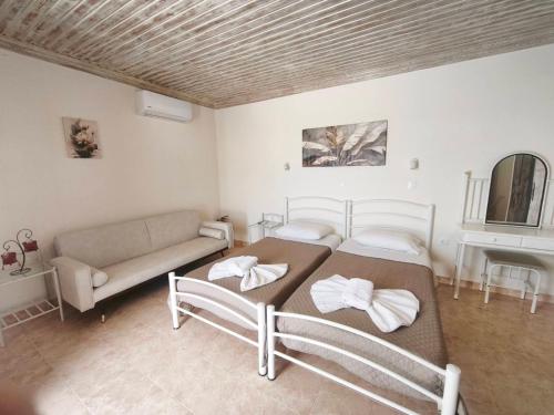 a living room with two beds and a couch at Irini Studios in Arkasa