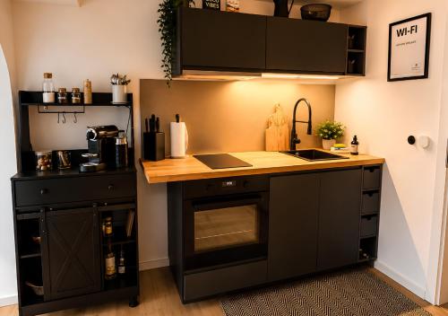 a kitchen with a sink and a counter top at Appartement - Eifelglück in Pelm