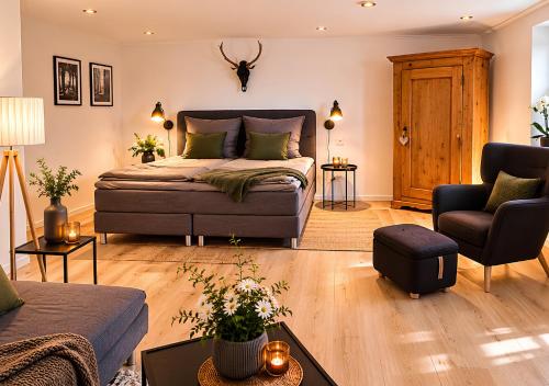 a bedroom with a bed and a living room at Appartement - Eifelglück in Pelm