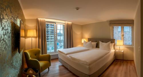 En eller flere senge i et værelse på Hotel Rappen am Münsterplatz
