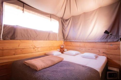 a bedroom with a large bed with a window at Camping Pays Basque in Bidart