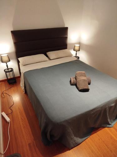 a large bed in a room with two lamps at Rooms in the center City in Barcelona