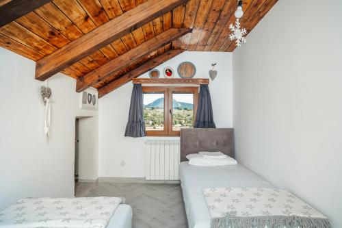 a bedroom with two beds and a window at Villa Elena in Cetinje