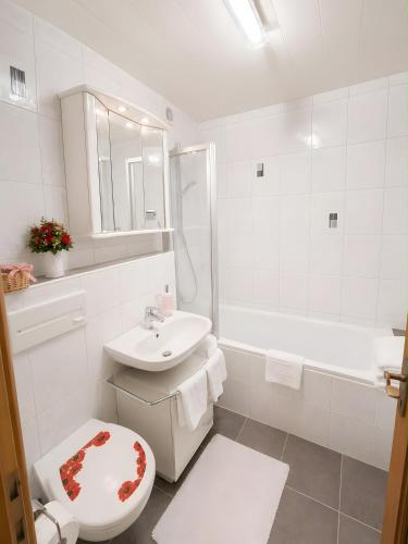 a white bathroom with a toilet and a sink at Ferienwohnung Hinterthal in Hinterthal