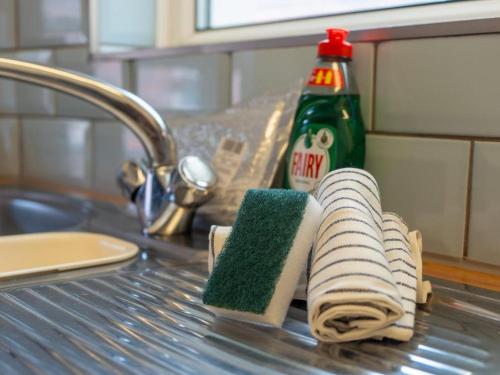a couple of towels sitting on a counter next to a sink at The Grimsby Heneage Stay in Grimsby