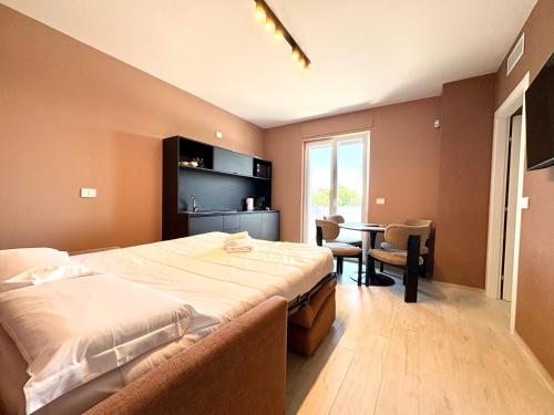 a bedroom with a large bed and a table in it at Mareka Luxury Apartments in Bari