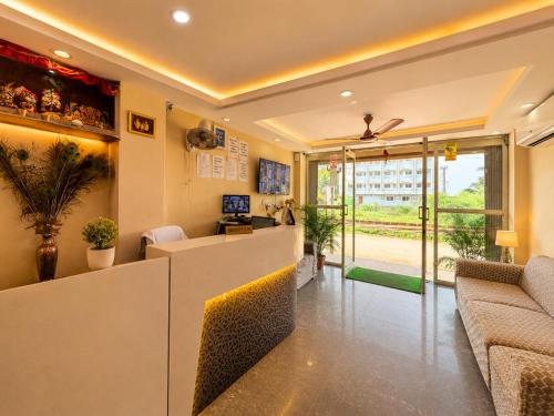 a lobby with a reception desk and a couch at Hotel Golden Wave Puri - Baliapanda Housing Colony - Near Golden Beach- Parking - Restaurant in Puri