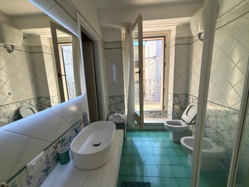 a bathroom with two sinks and two toilets at B&B Vela Sea in Civitanova Marche