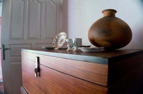 a wooden cabinet with a vase on top of it at Whispering House in Tangalle