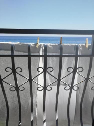 a window with a view of the ocean from a balcony at B&B BnBeach in Varazze