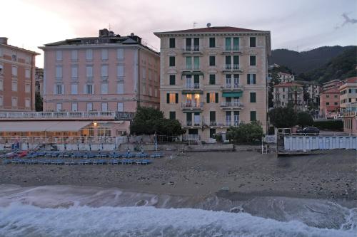 a group of buildings on a beach with water at B&B BnBeach in Varazze