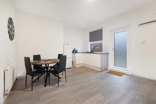 a dining room and kitchen with a table and chairs at Cosy 2BR Apartment Sleeps 4 by Stay With Us in Hawthorn