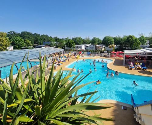 a group of people in a pool at a resort at Camping les Chalands Fleuris in Saint-André-des-Eaux