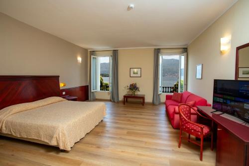 a hotel room with a bed and a flat screen tv at Europalace Hotel in Verbania