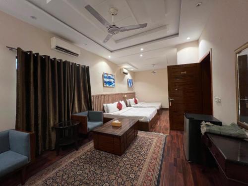a living room with a couch and a table at Shelton Hotel Gulberg in Lahore