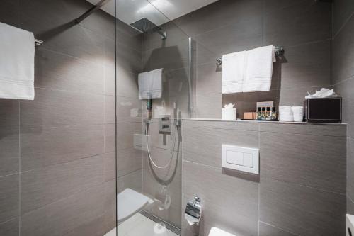 a bathroom with a shower with a glass door at Hotel Bristol Verbier in Verbier