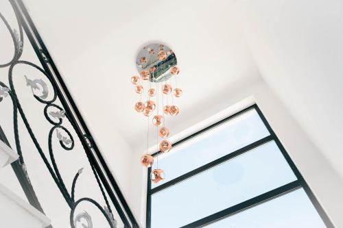 a chandelier of pearl earrings hanging from a glass door at Hotel Platino Prestige in Ulcinj