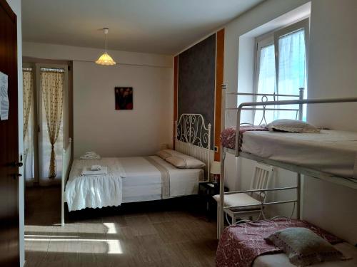 a bedroom with two bunk beds and a window at La Dolce Dimora in Praia a Mare
