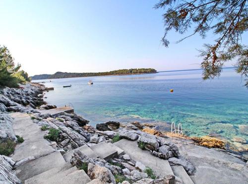 a view of a body of water with rocks at Apartments Bacic in Prizba