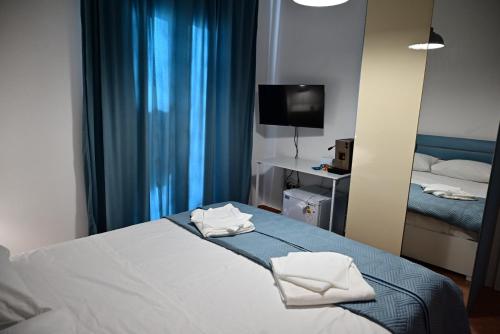 a hotel room with a bed and a mirror at Casa Marina in Balestrate