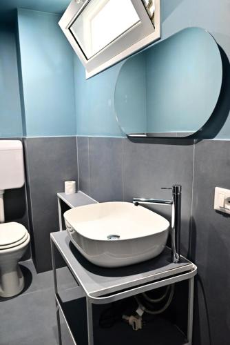 a bathroom with a sink and a mirror at Casa Marina in Balestrate