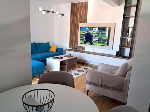 a living room with a couch and a table at Apartpan Lekic in Bar