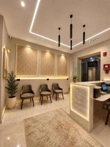 a lobby with chairs and a desk and a counter at Havana ViP in Cairo