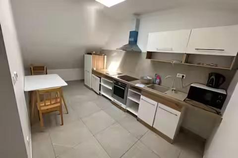 a kitchen with a sink and a table in it at Meštiansky dom in Stupava