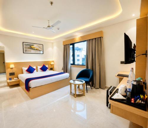 a hotel room with a bed and a tv at Zip by Spree Hotels R Group Kota - Near Coaching Hub & Oxy Park in Kota