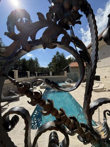 a metal fence with a pool in the background at Divski Resort in Divčibare