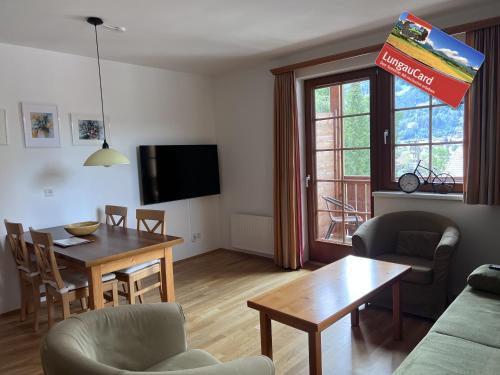 a living room with a table and a dining room at Stranach Appartements in Sankt Michael im Lungau