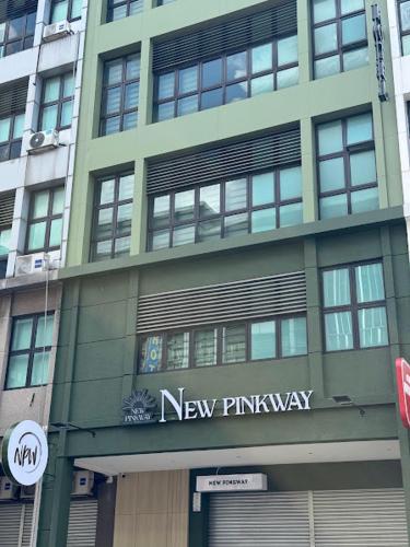 a building with a new pharmacy sign on it at USJ NPW New PinkWay Hotel in Subang Jaya