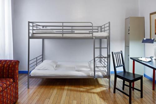 a bunk bed in a room with a chair and a desk at Central Park West Hostel in New York