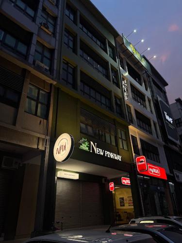 a building with a new trump sign on it at USJ NPW New PinkWay Hotel in Subang Jaya