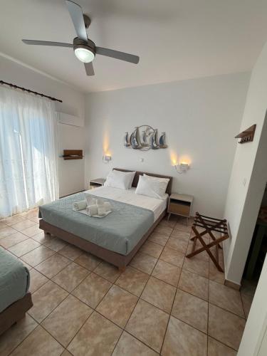 a bedroom with a bed and a ceiling fan at Studios Panorama Drios in Drios