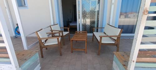 a group of chairs sitting on a porch at Il Soffione in Castelsardo