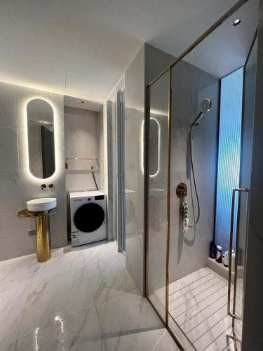 a bathroom with a shower and a sink at Vue Aston in Phnom Penh