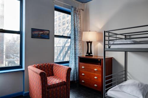 a bedroom with a chair and a bunk bed at Central Park West Hostel in New York