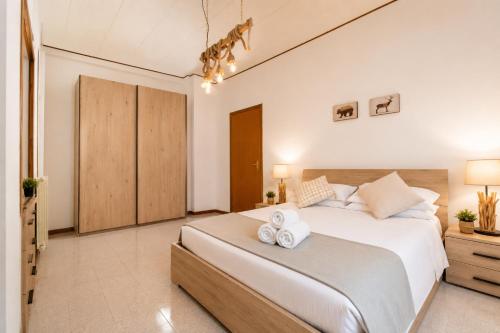 a bedroom with a large bed with two towels on it at Luna al Monte in Cuasso Al Monte