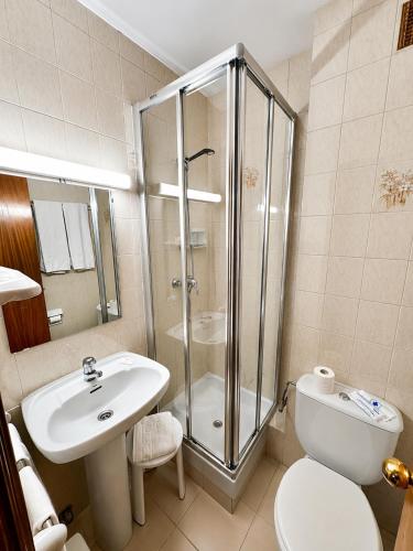 a bathroom with a shower and a toilet and a sink at Hotel Casado in Pas de la Casa