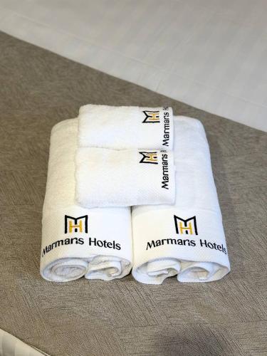 two white towels sitting on top of a table at Marmaris Rakat Hotel in Yakkasaray