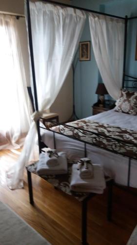 a bedroom with a bed and a table with towels at Koustenis Village in Dhimitsana