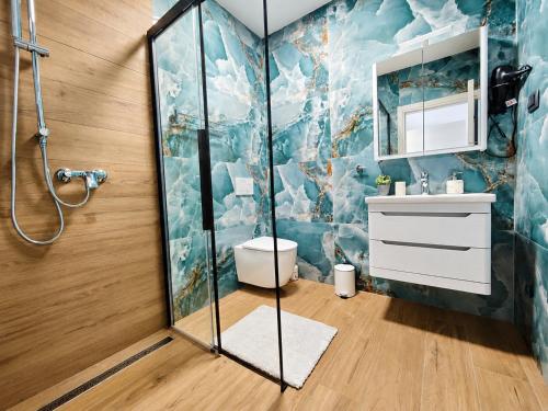 a bathroom with a shower and a toilet and a sink at Villa Dijana with Pool - Sol Tours in Kras
