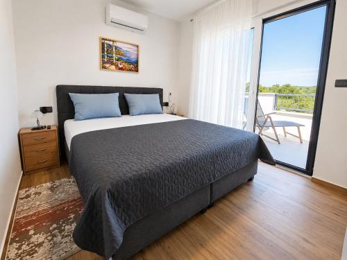 a bedroom with a large bed and a balcony at Villa Dijana with Pool - Sol Tours in Kras