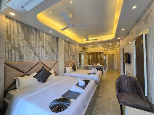 a hotel room with two beds and a tv at Parth King Resort Tarapith A Unit of Prattay Infratech Private Limited in Tarapith
