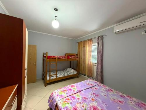a bedroom with a bed and a bunk bed at Alexa Beach Apartment in Velipojë