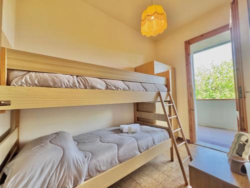 a bedroom with two bunk beds and a ladder at Villetta Mascagni in Lido Adriano