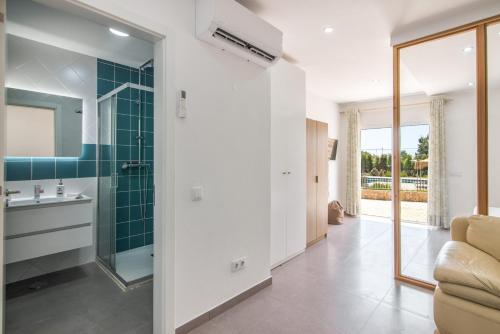 a bathroom with a sink and a glass shower at Vilas Salero in Moncarapacho